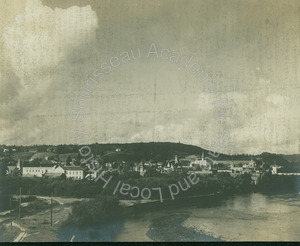 Image of View of unidentified town, with a YMCA building in foreground