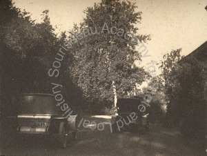 Image of Two parked autos at New Almaden