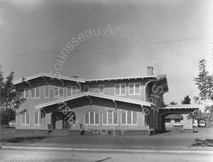 Image of Front view of a two-story house with porte cochere