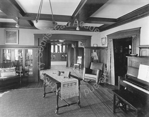 Image of View of living room with piano and table in center