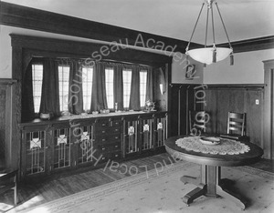 Image of Dining room with cabinets along wall, and table in center of room