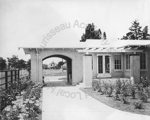 Image of View of backyard and gardens of a home with a porte cochere