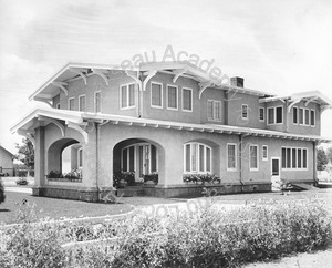 Image of View of the back of a two-story house with a cellar and porte cochere