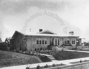 Image of Front view of a house with a porte cochere 