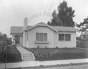 Image of Front view of house numbered 135 with walk to door