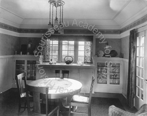 Image of View of dining room with table and chairs, built-in cabinets