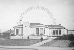 Image of Front view of house numbered 452 from street with child in driveway