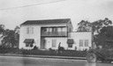 Image of Hempl house, view of front, with an automobile at the curb